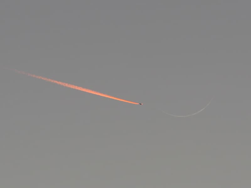 Jet Approaching a Crescent Moon