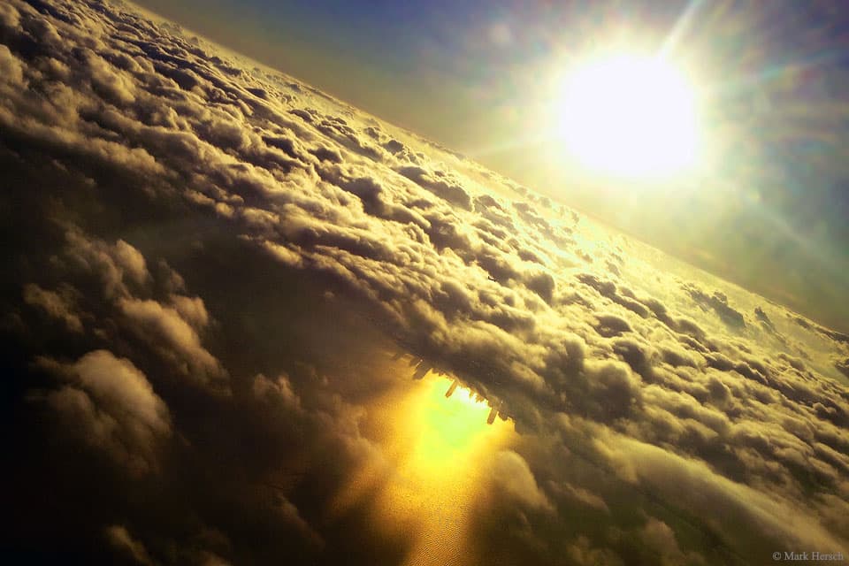 Inverted City Beneath Clouds